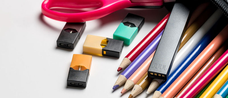 Juul next to pencils